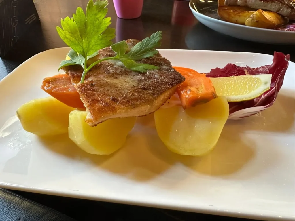 Gebratenes Lachsfilet mit Salzkartoffeln, Karotten und Petersilie im The Dom Konstanz