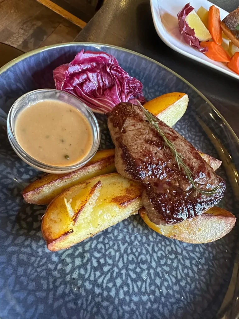 Gegrilltes Steak mit Rosmarinzweig, Kartoffelecken und Pfeffersauce im The Dom Konstanz